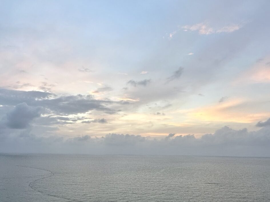 Sunset over the ocean in Bocagrande, Cartagena, Colombia, with the city skyline in the background.