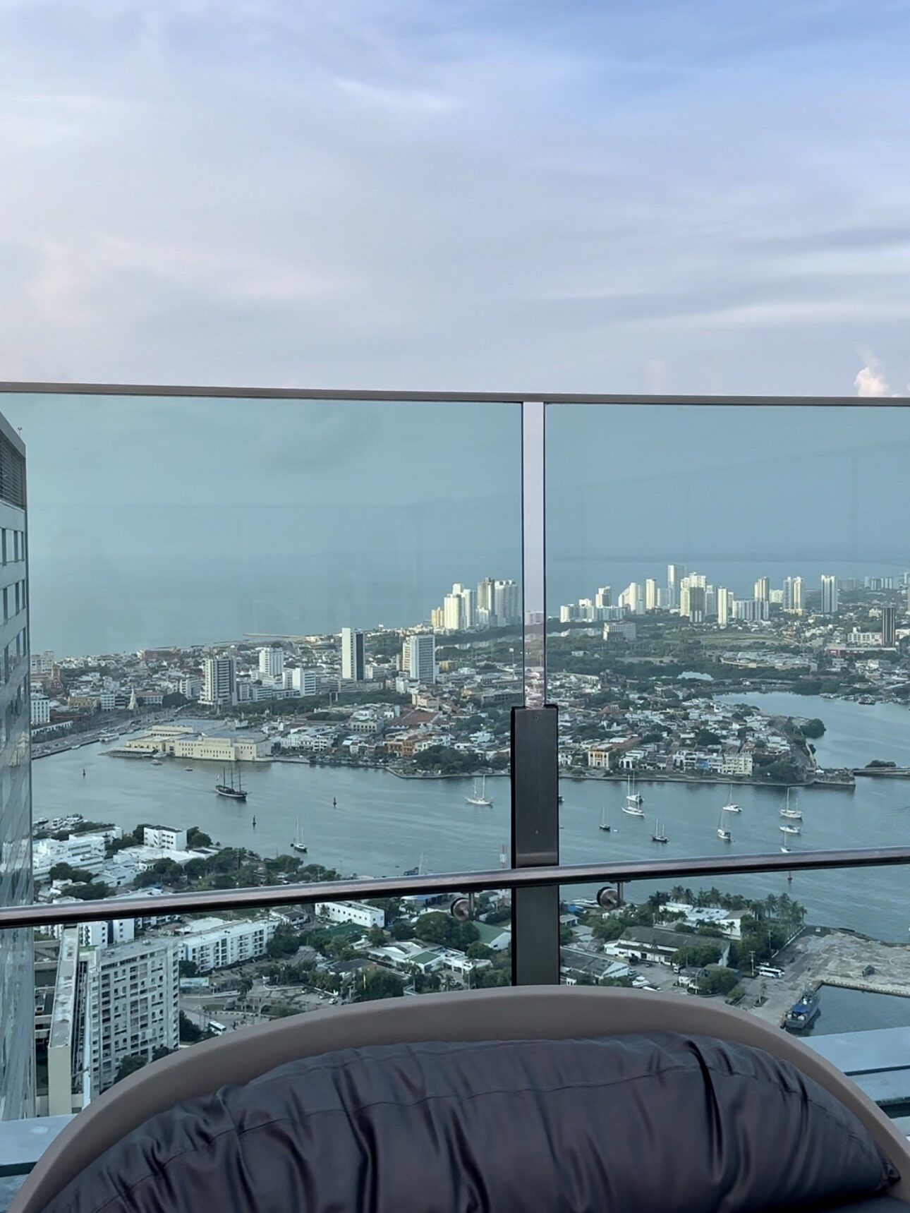 Rooftop view from 51 Sky Bar in Bocagrande, Cartagena, Colombia, showcasing city skyscrapers, the bay, and a stunning sunset.