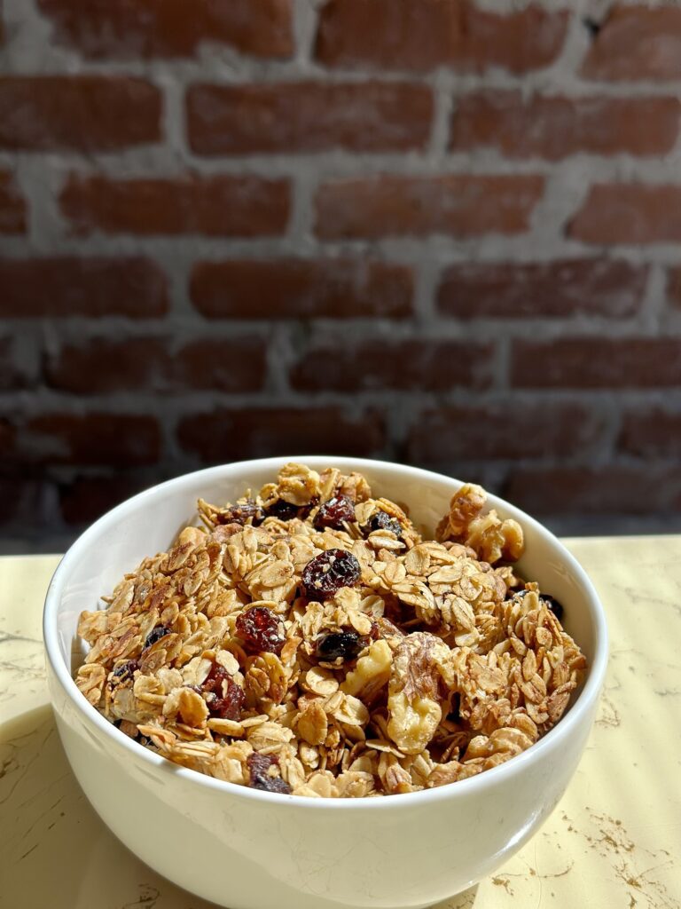 Easy homemade granola made with oats, maple syrup, and coconut oil in a baking tray
