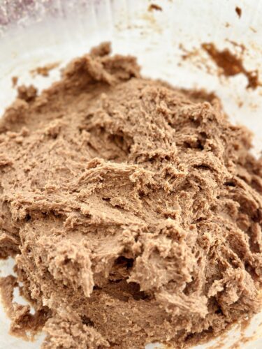 Close-up of chocolate frosting or spread, featuring a creamy, textured consistency.