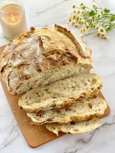 Sliced Sun-Dried Tomato Dill Artisan Bread showing an open, chewy crumb