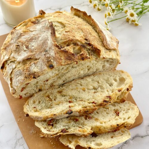 Sliced Sun-Dried Tomato Dill Artisan Bread showing an open, chewy crumb