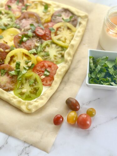Puff pastry edges folded over the tomato and feta filling before baking
