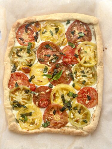 Overhead view of a golden baked heirloom tomato puff pastry tart fresh out of the oven