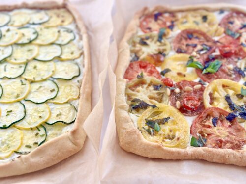Top view of a finished tomato tart showing red, yellow, and orange heirloom tomato slices